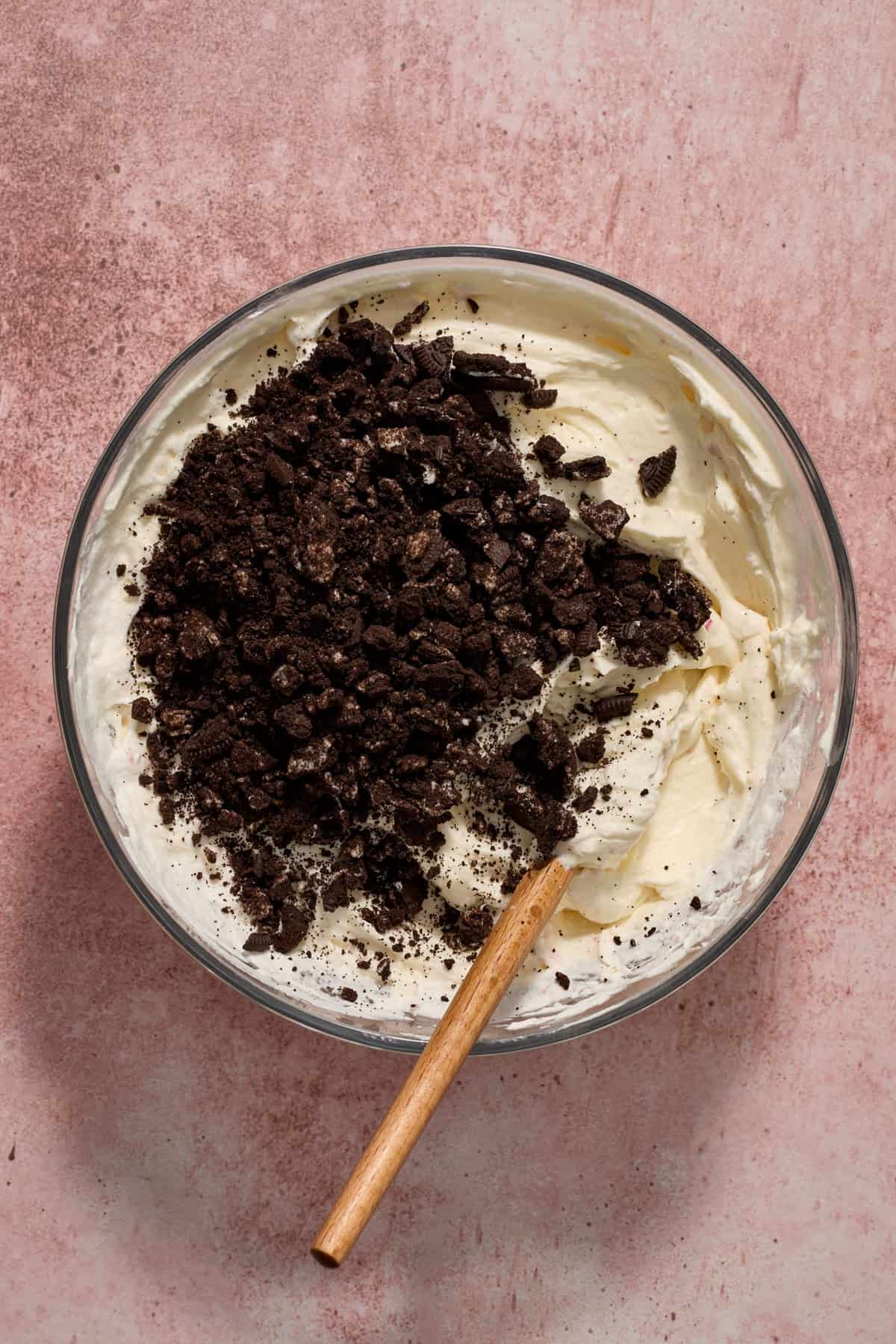 Crushed Oreos added to no bake cheesecake mixture.