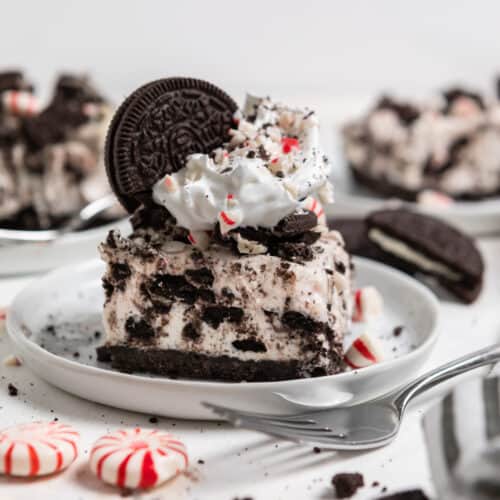 White plate with no bake peppermint cheesecake with oreos and candy canes.