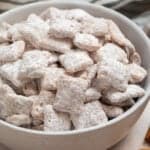 Cinnamon puppy chow chex mix in white bowl.