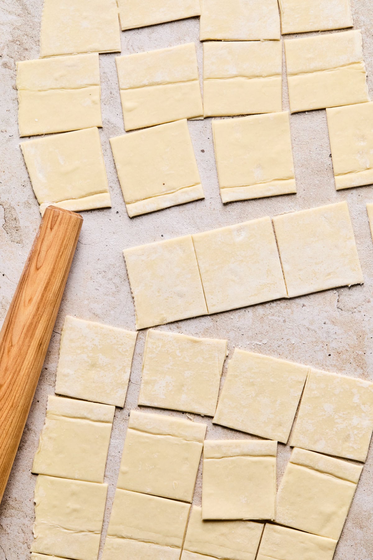 Cut puff pastry on surface with rolling pin.
