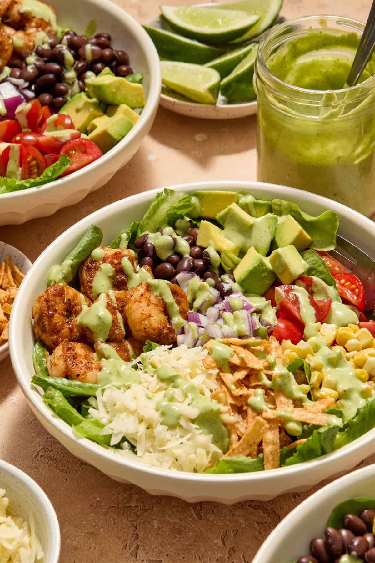 Shrimp taco salad prepared in bowl with dressing drizzled over top.