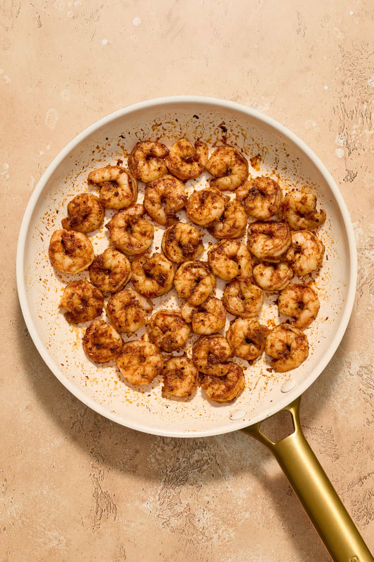 Cooked shrimp in skillet.