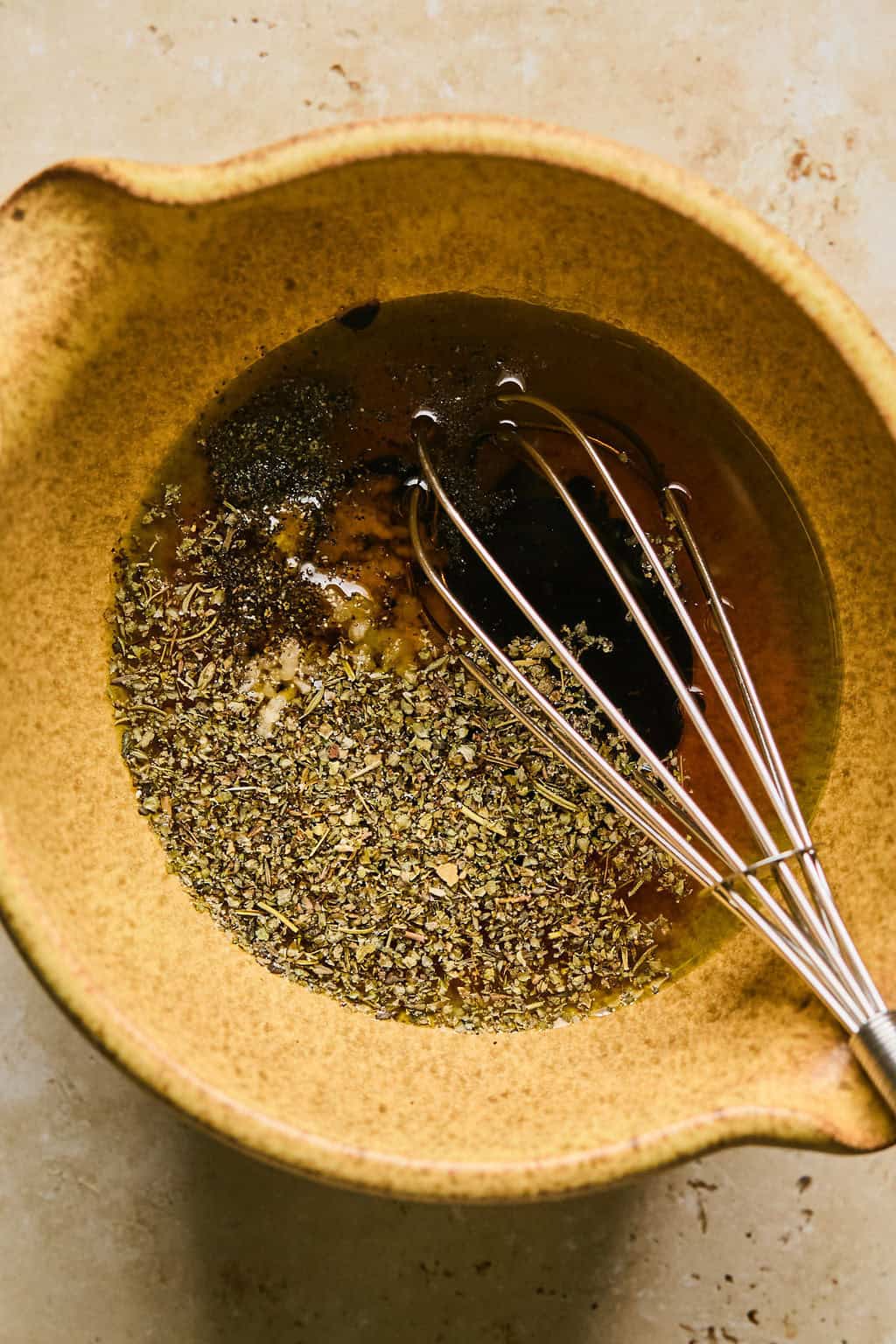 Whisk in bowl with sun dried tomato dressing.