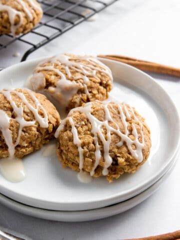 White plate with iced cinnamon breakfast cookies.
