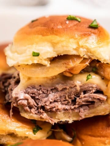 Roast beef slider with cheese, onion and mushrooms.
