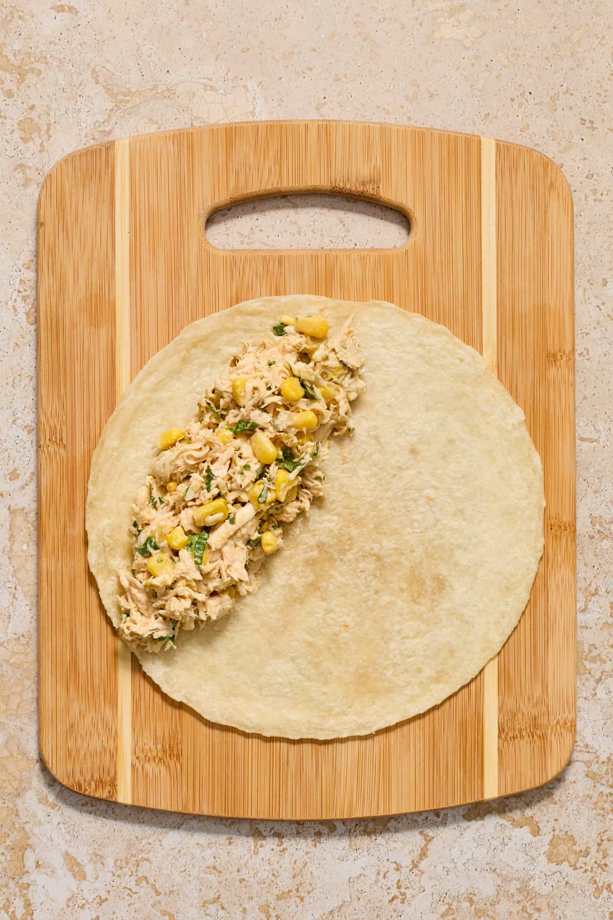 Chicken enchilada mixture on tortilla.