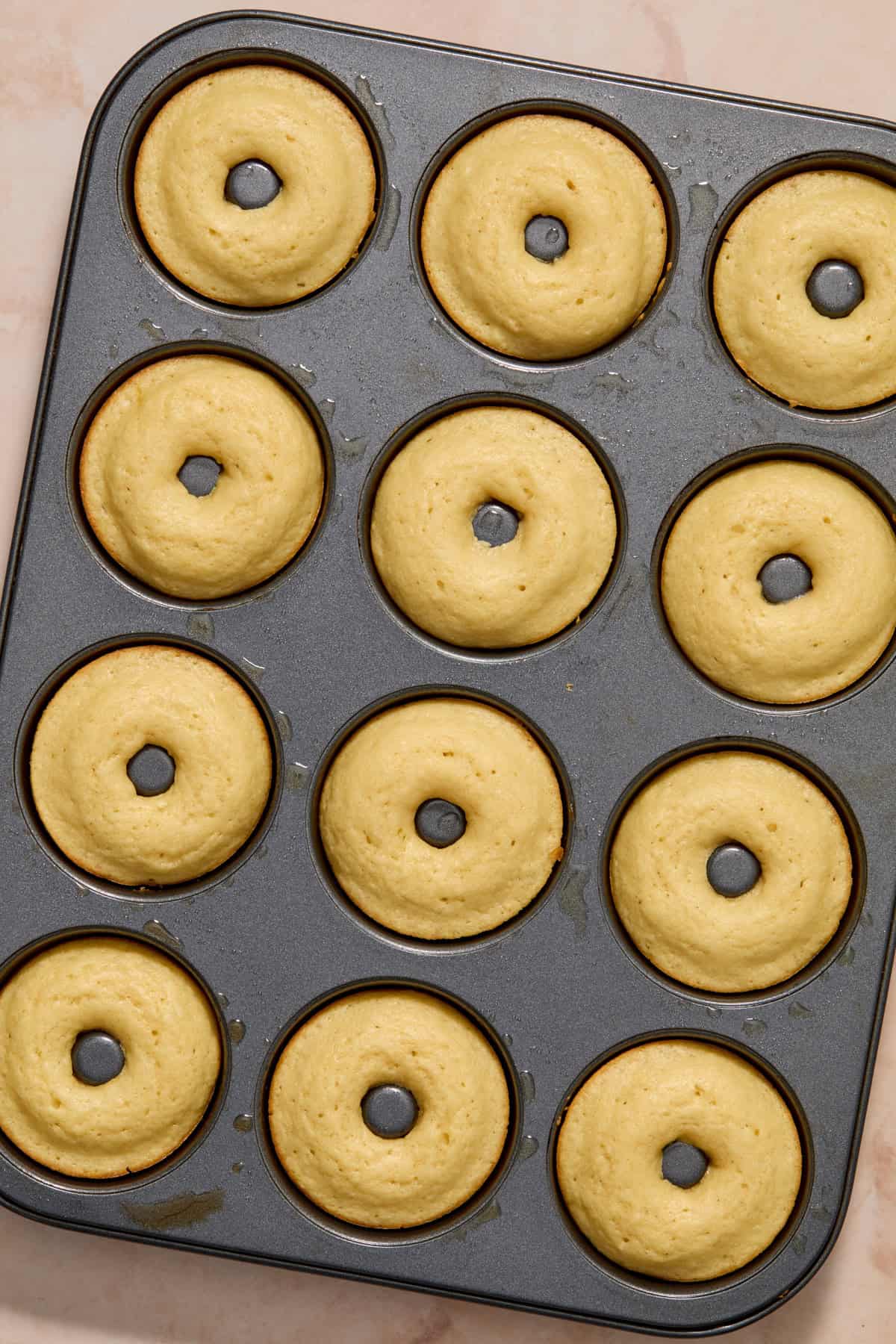Baked vanilla donuts in donut pan.