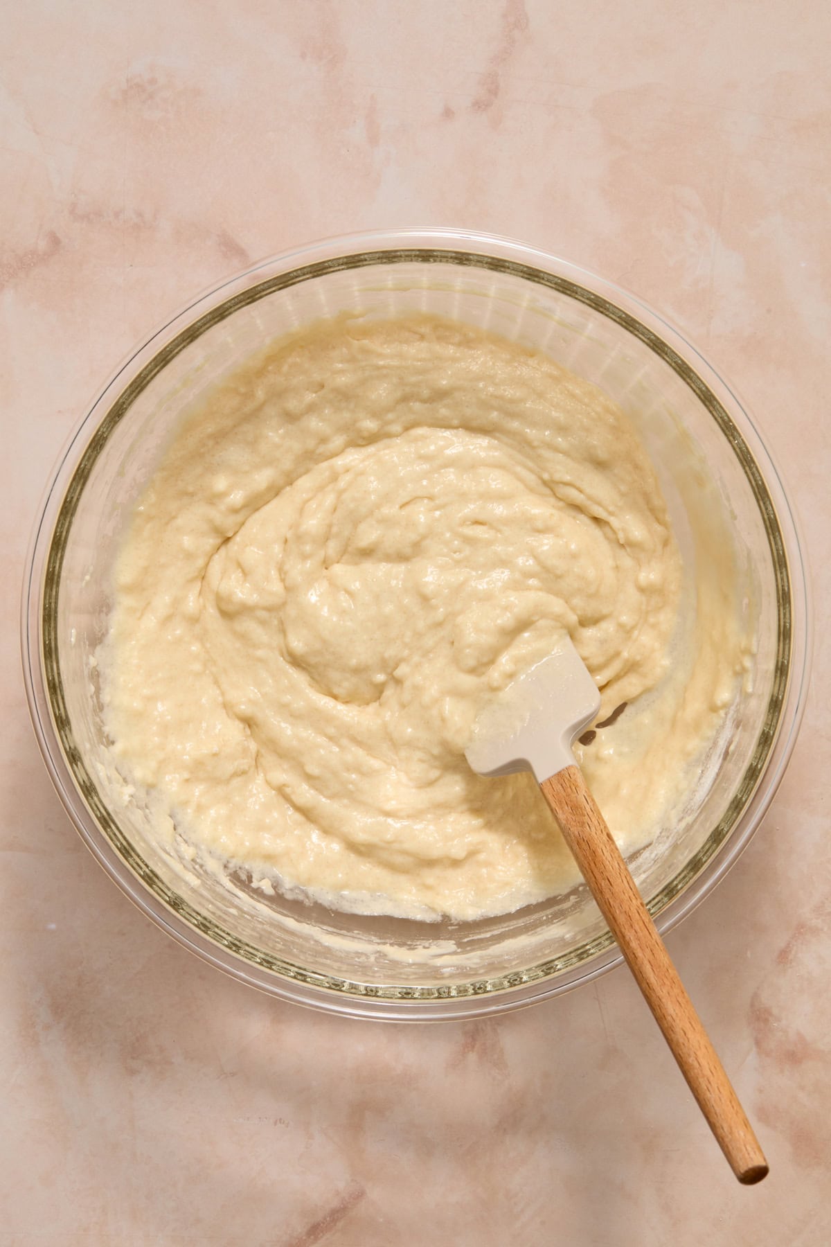 Vanilla donut batter in bowl with spatula.