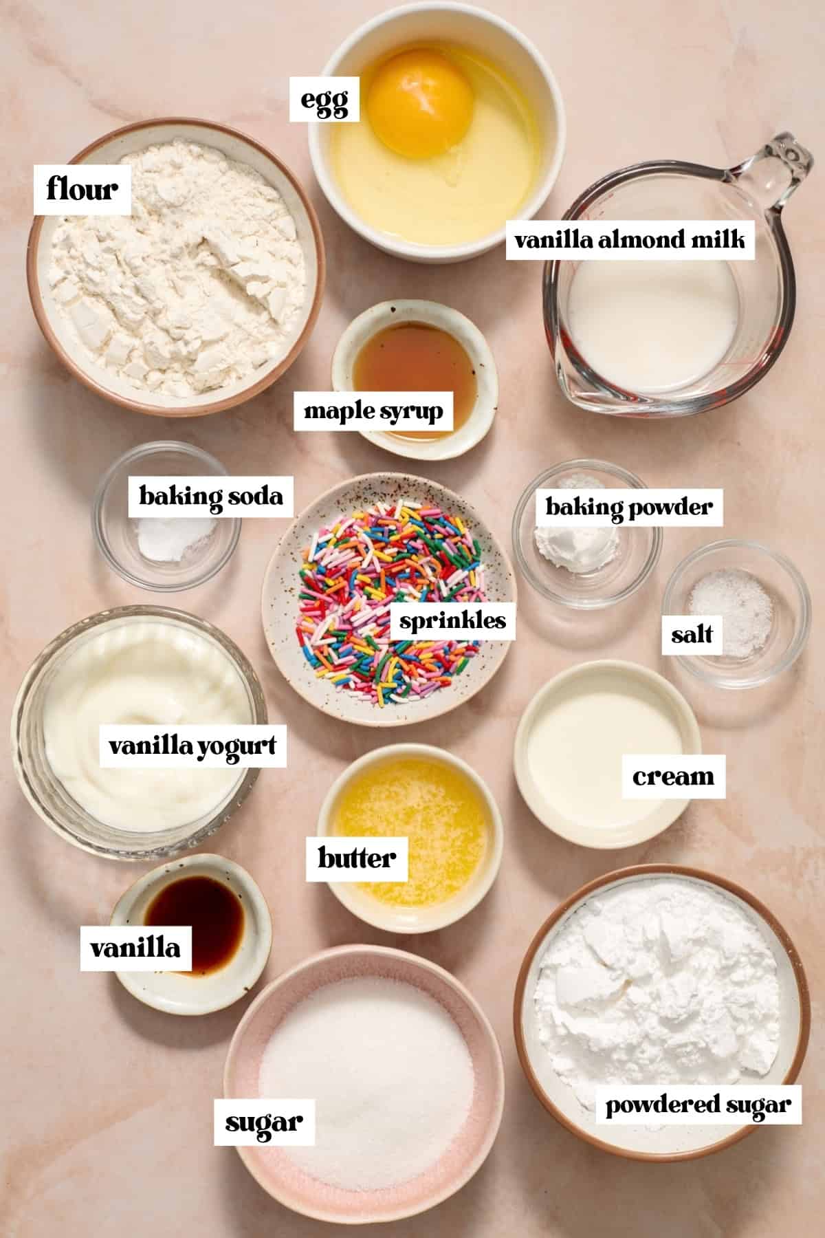 Flour, butter, sugar and other ingredients labeled on surface.