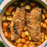 Dutch oven with roasted pork tenderloin, carrots and potatoes.