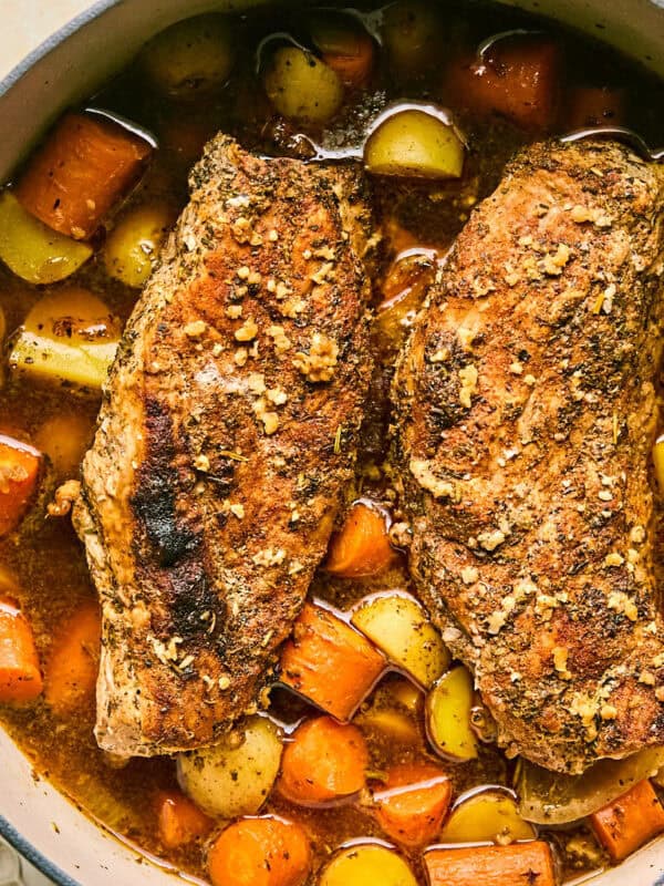 Dutch oven with roasted pork tenderloin, carrots and potatoes.