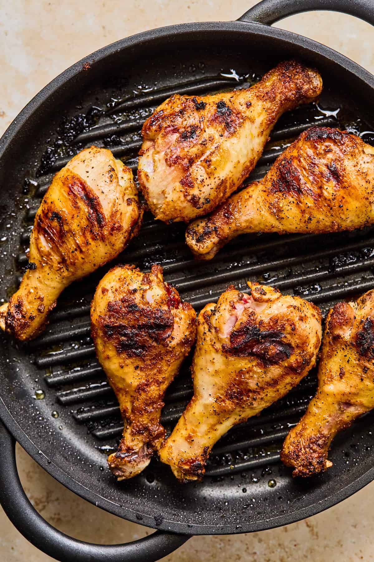 Grilled chicken legs on indoor grill pan.