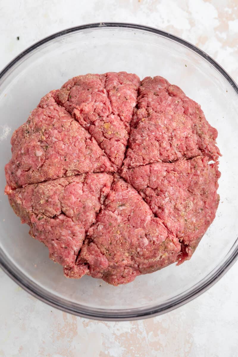 Ground chuck burger ingredients mixed and divided into 6 pieces.