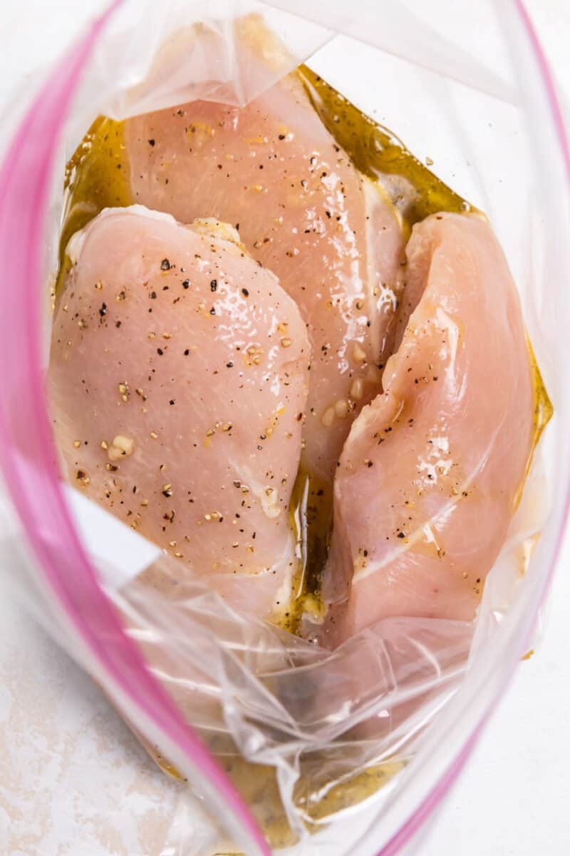 Marinade poured over chicken breast.