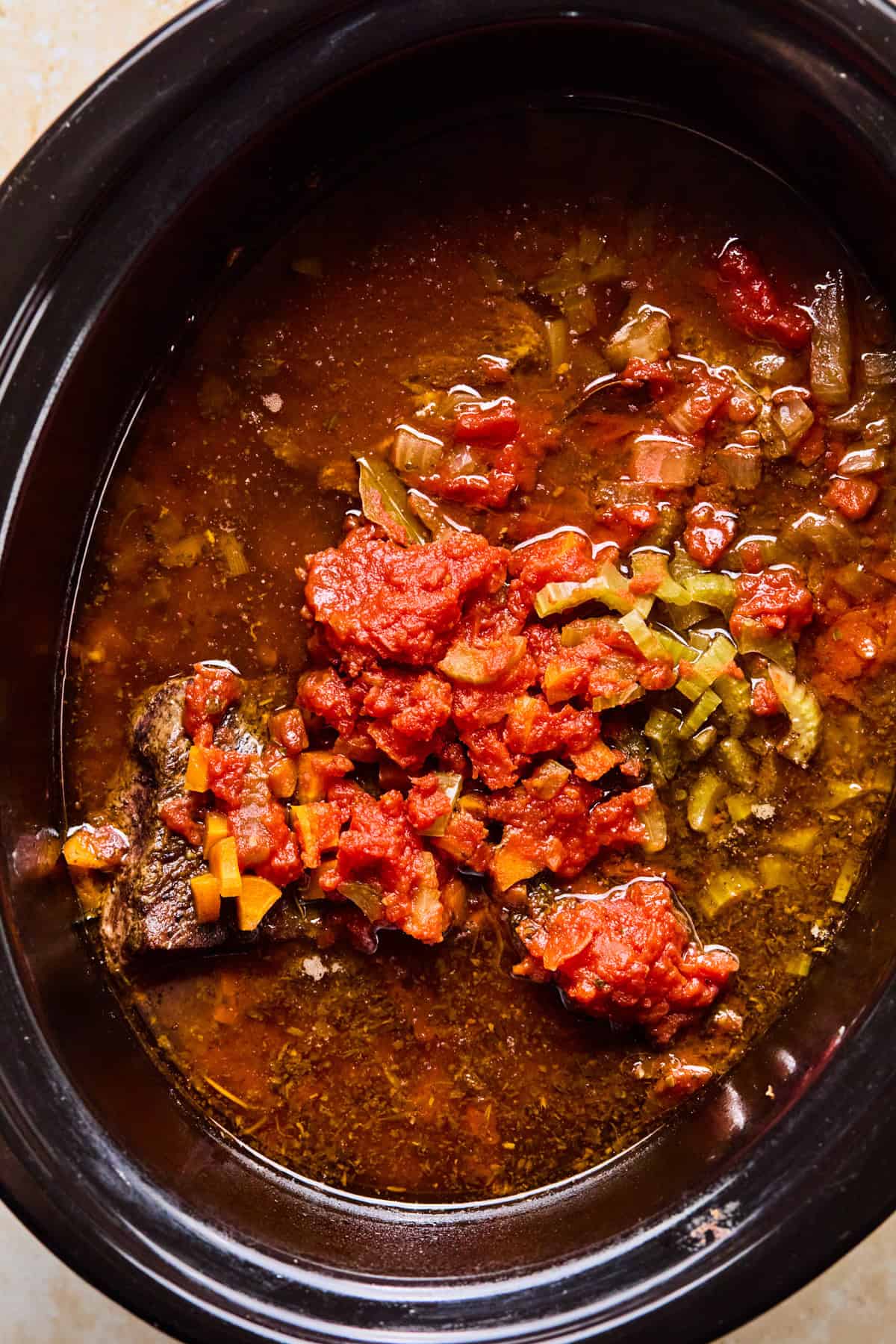 Cooked short rib ragu in crockpot before meat is pulled.