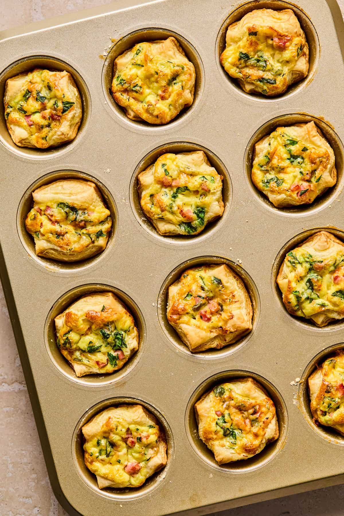 Baked mini quiche in puff pastry.