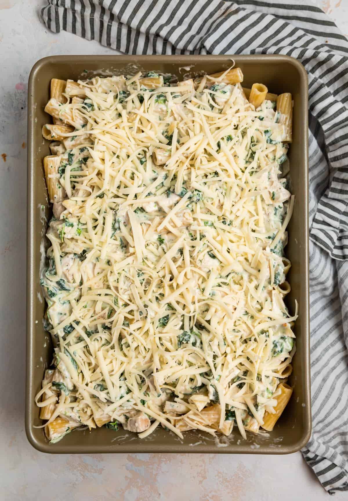 Casserole dish with shredded cheese on top.