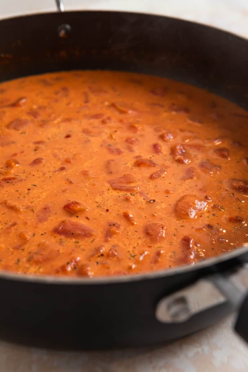 Spicy sausage tomato cream sauce in skillet.
