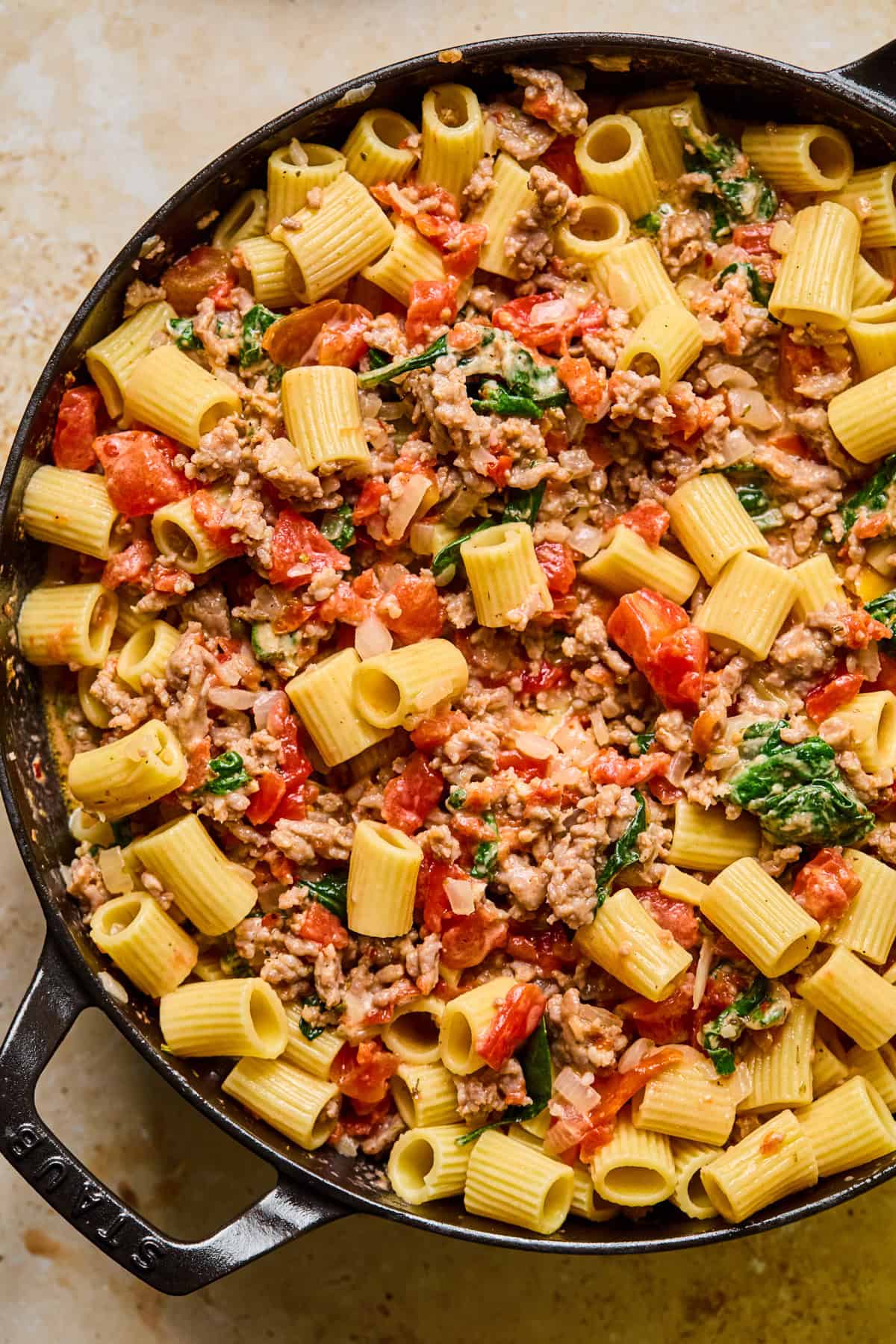 Italian sausage pasta in cast iron skillet.