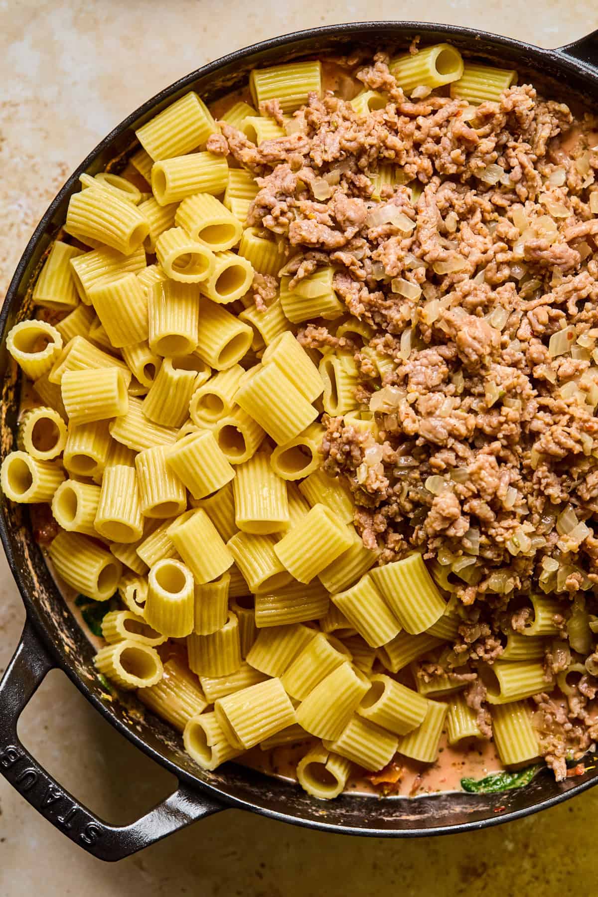 Pasta and sausage added to pan.