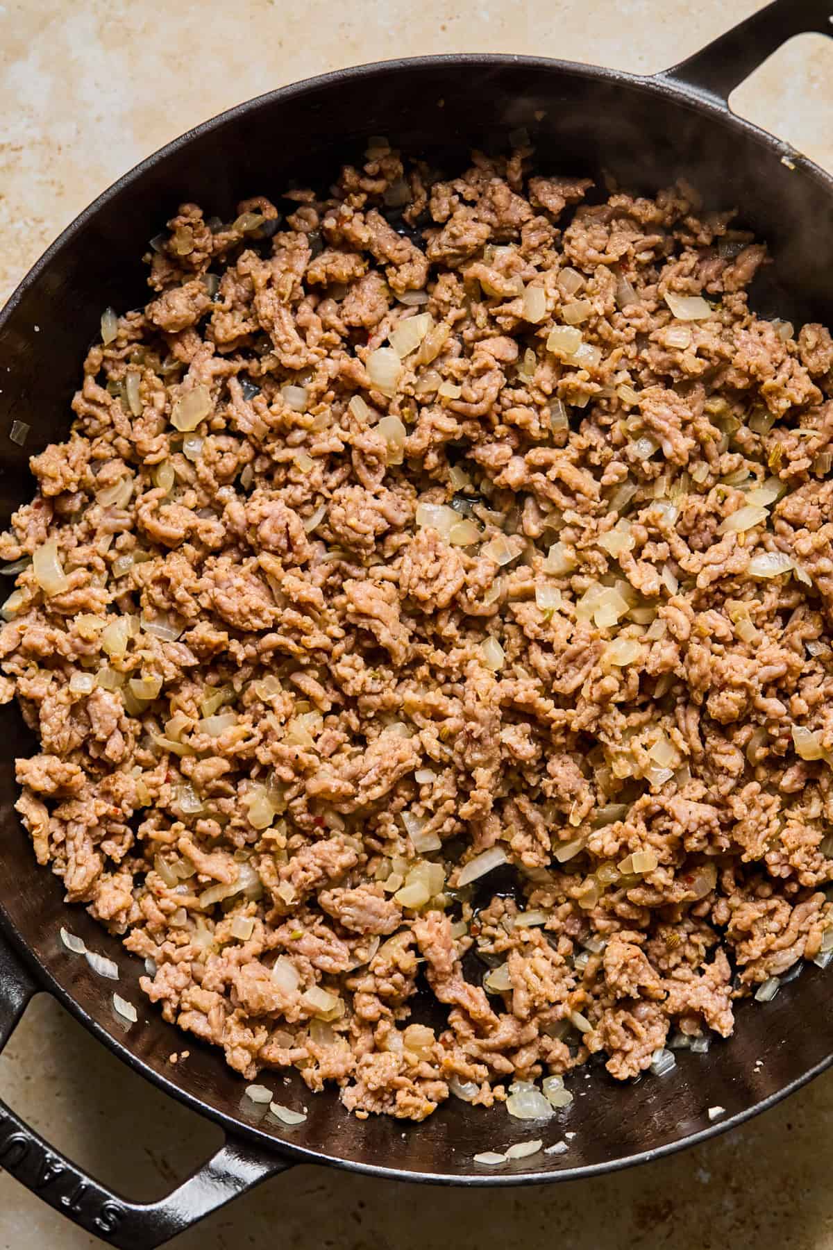 Browned sausage and onions in skillet.