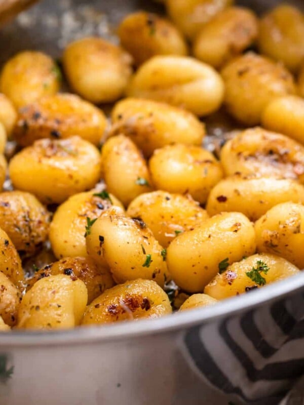 Pan fried gnocchi tossed in butter and parmesan and topped with chopped parsley.