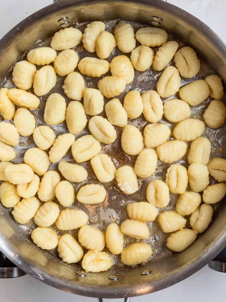 Skillet with uncooked gnocchi.