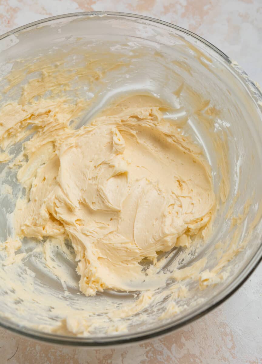 Creamed butter in glass mixing bowl.