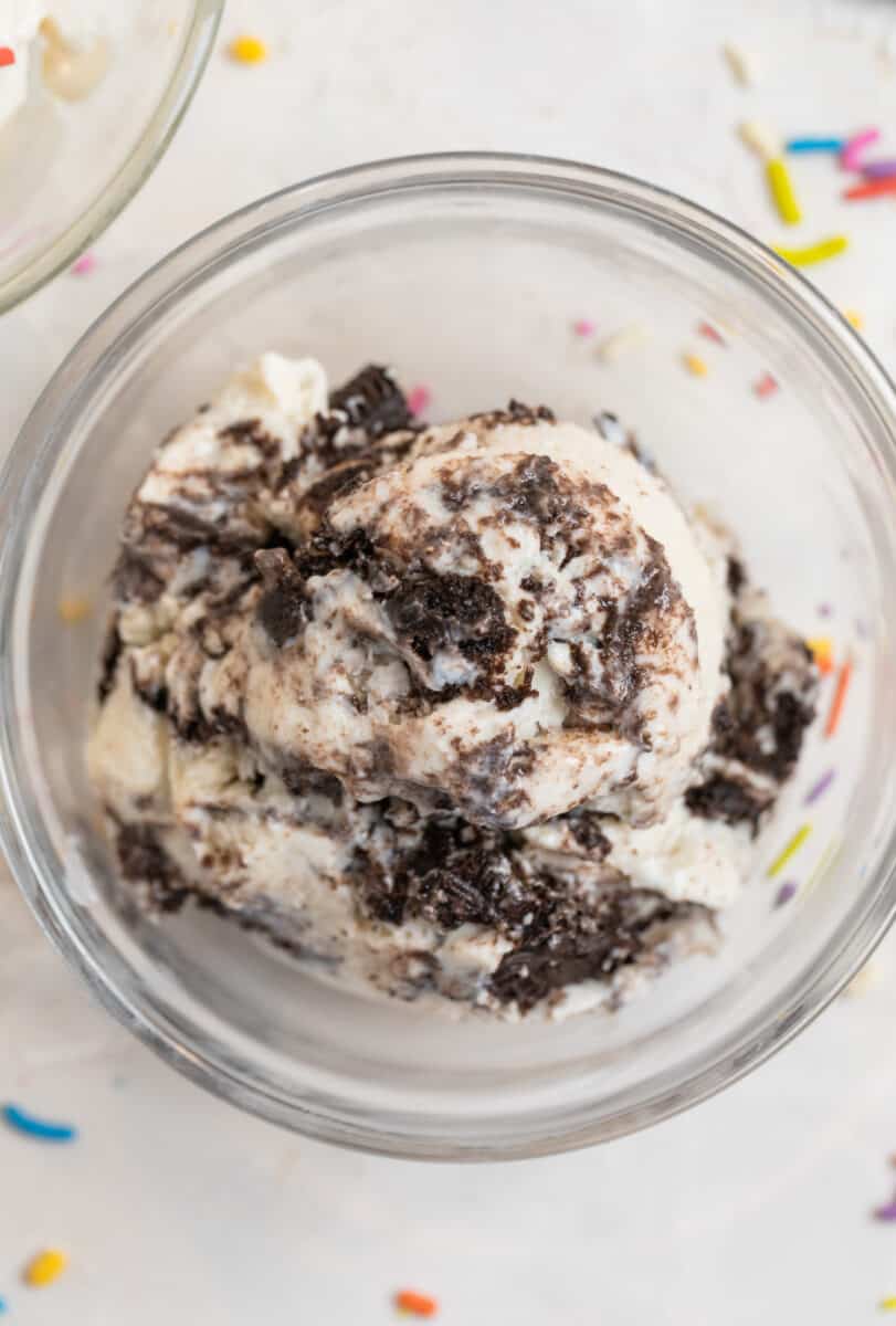 Oreo ice cream in glass dish.