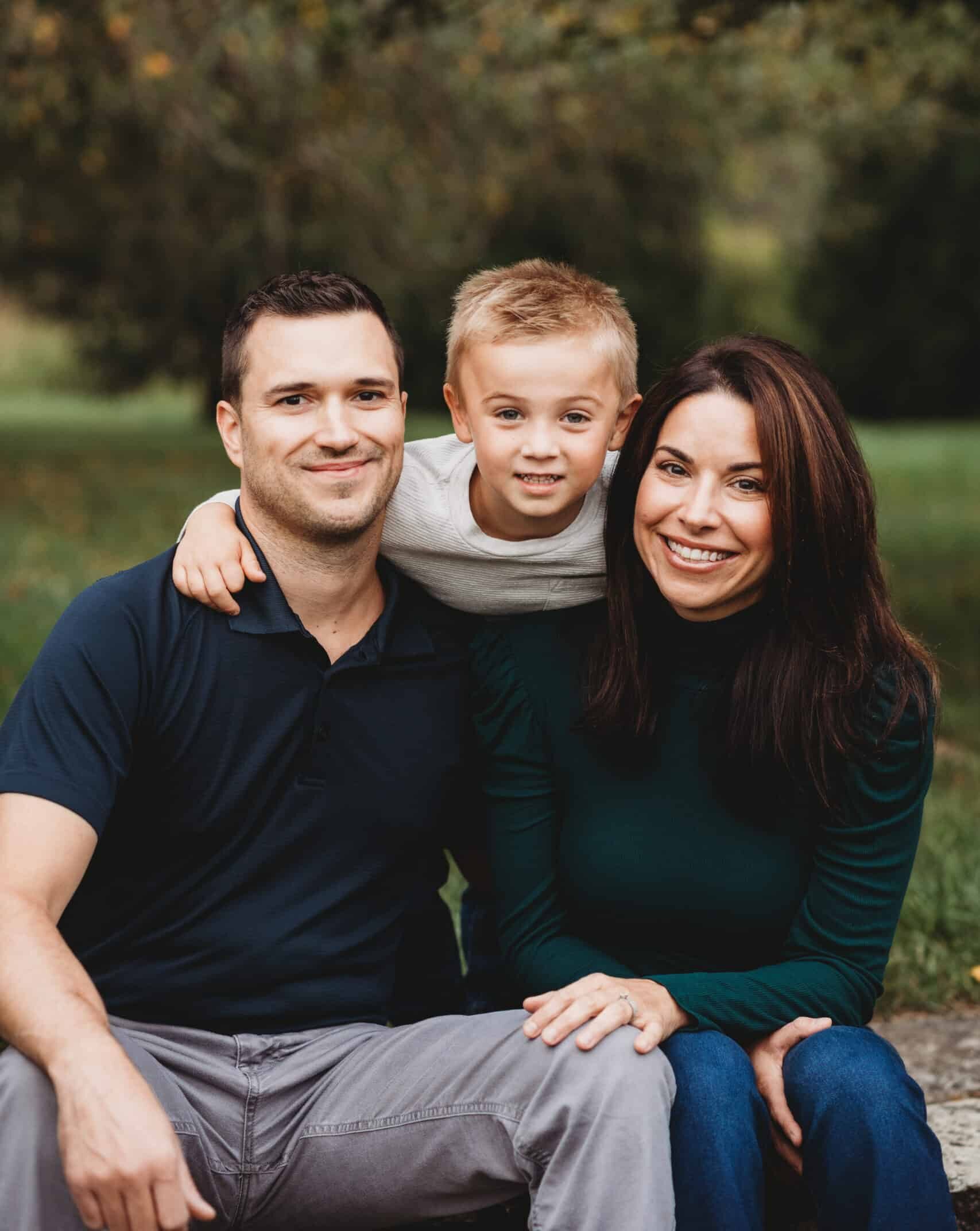 Lorie Yarro with son and husband seated on stone steps.