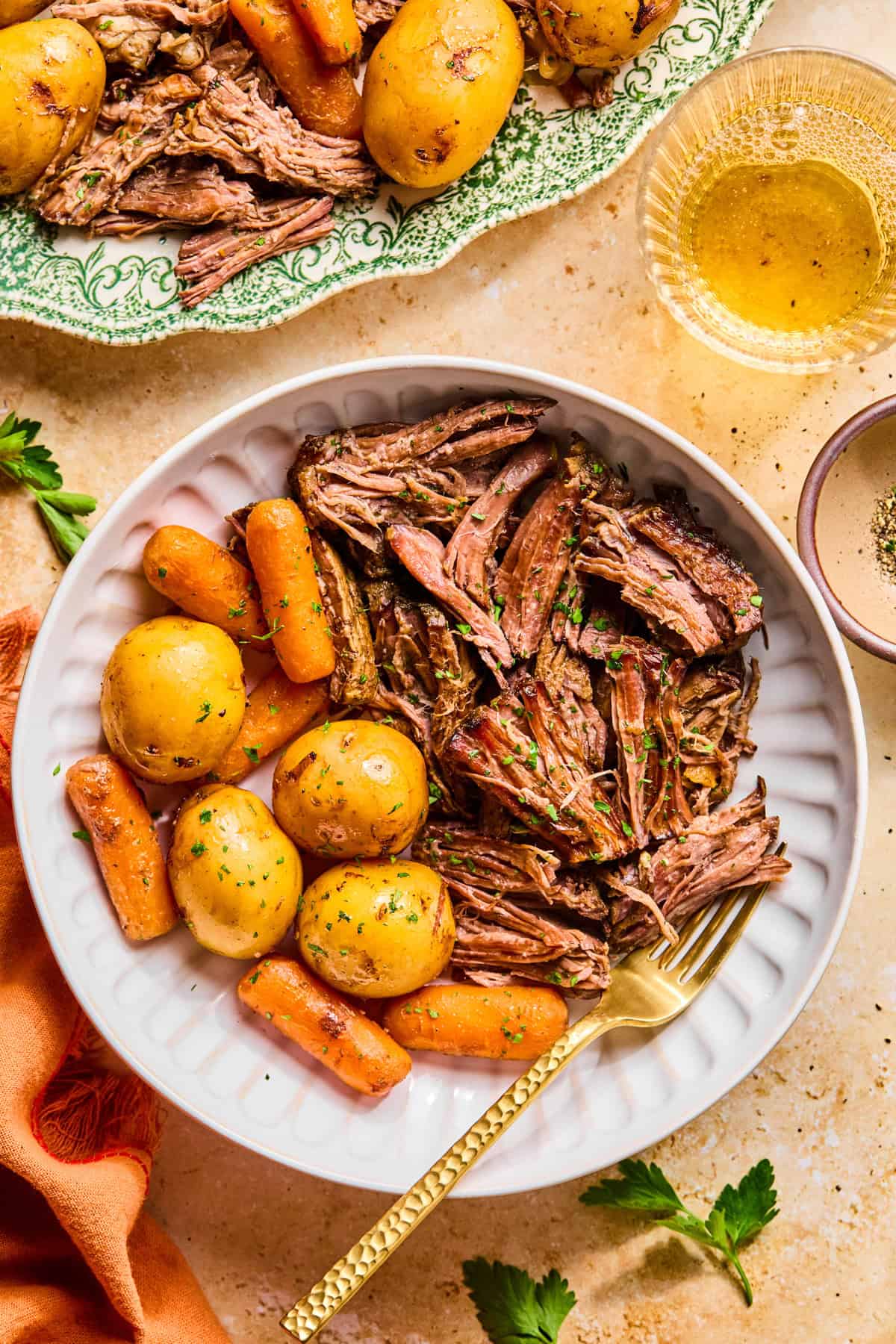 Plate with pot roast served and fork propped on plate.