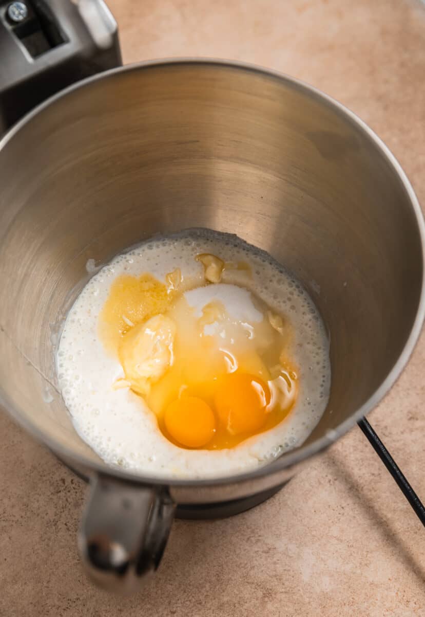 Egg, butter and sugar added to yeast and buttermilk mixture in stand mixer bowl.