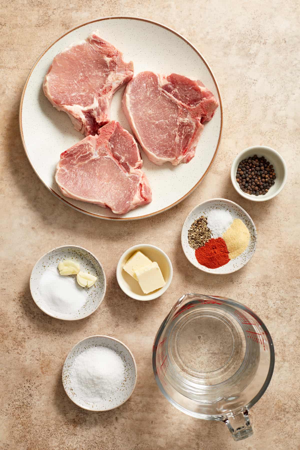 Pork chops, seasoning, water, butter and other ingredients to make cream of mushroom pork chops.