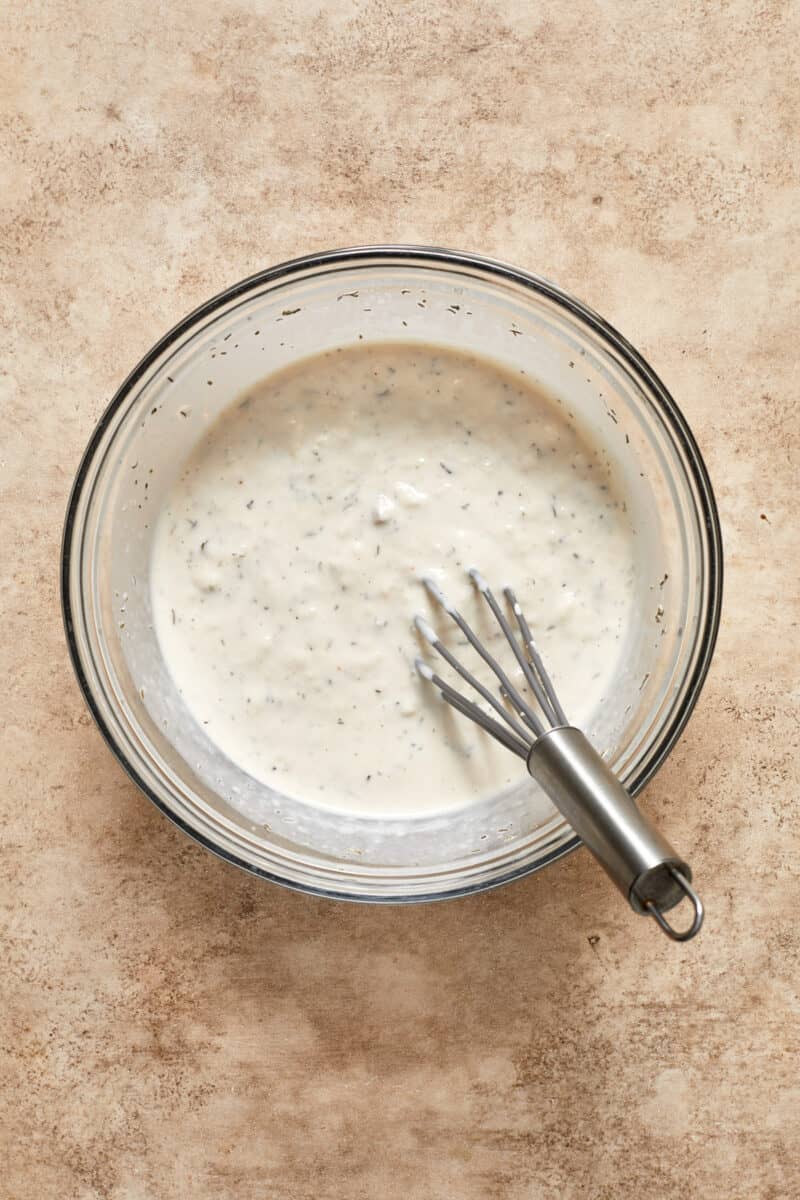 Cream of mushroom mixture in bowl with whisk.
