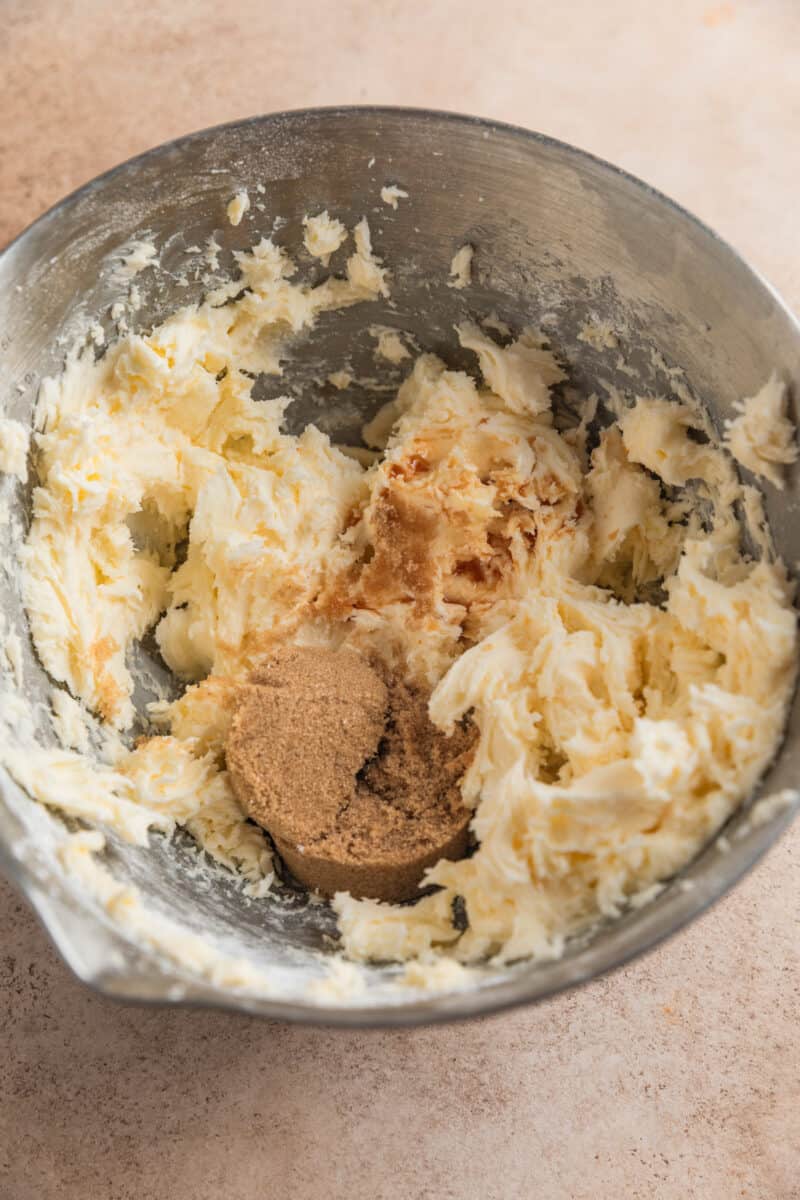 Brown sugar added to mixing bowl with creamed butter.