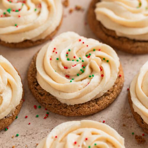 Ginger cookies with buttercream frosting and red and green sprinkles.