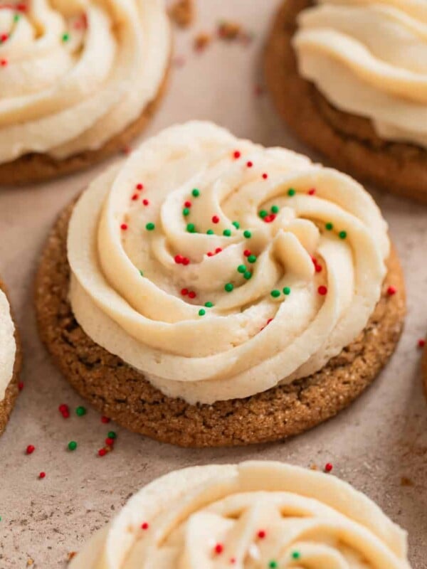 Ginger cookies with buttercream frosting and red and green sprinkles.