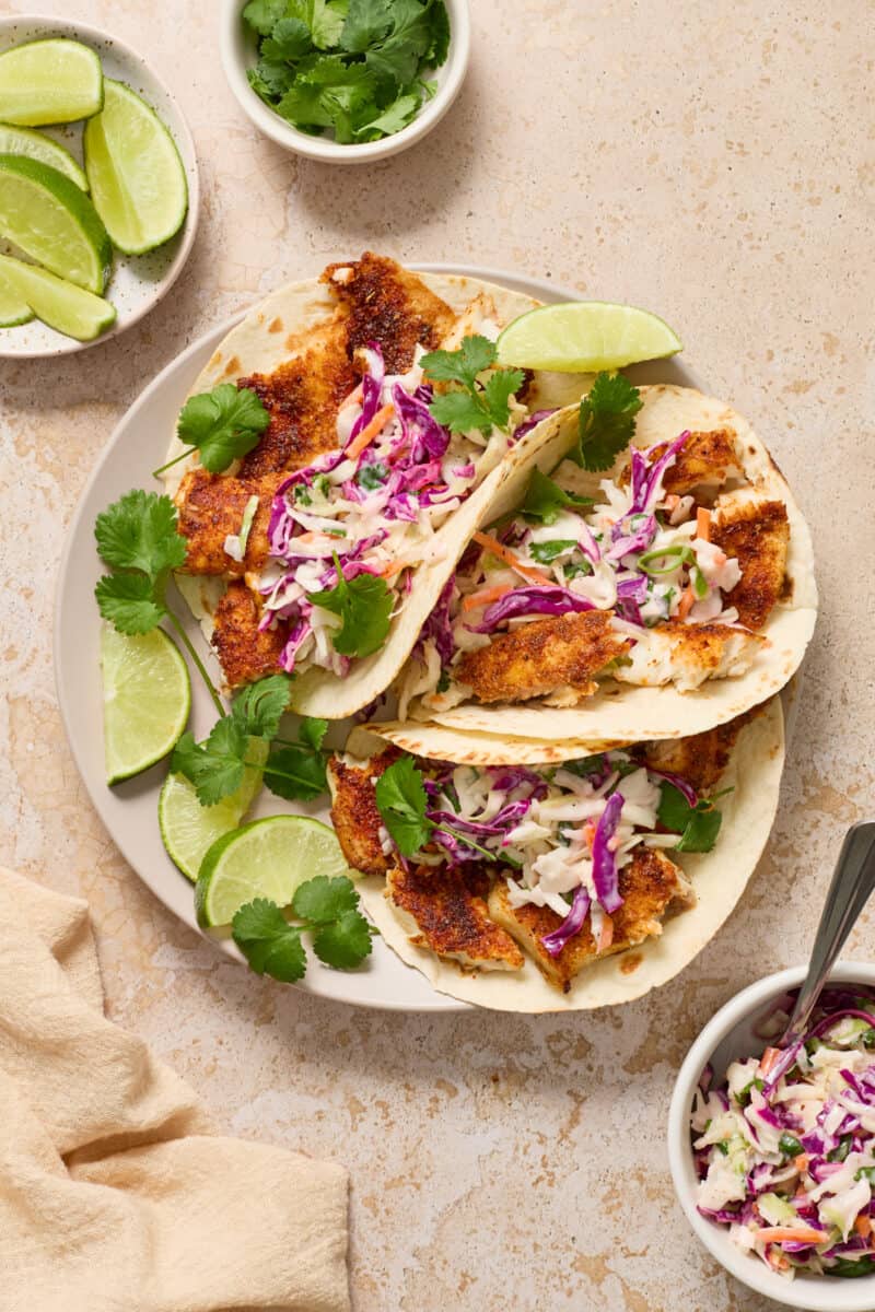 Air fried fish tacos topped with slaw.