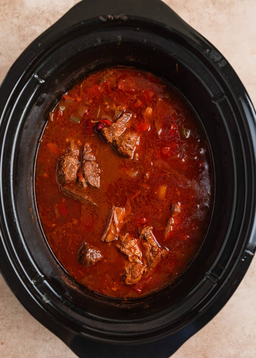 Cooked slow cooker chili before beef is shredded.