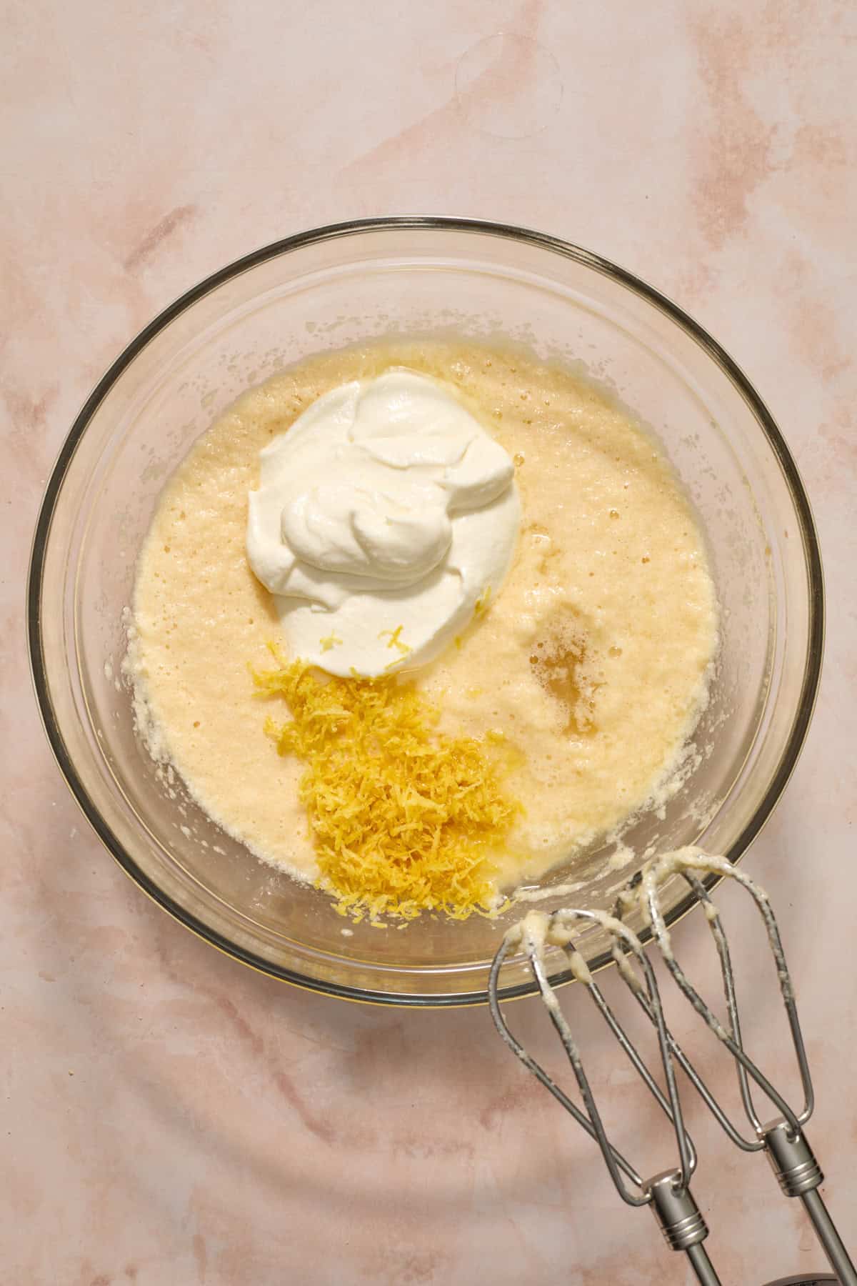 Sour cream, lemon zest and lemon juice added to bowl with wet ingredients.