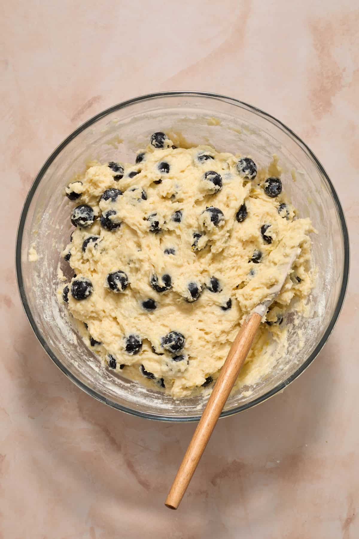 Blueberry lemon coffee cake batter in bowl with spatula.