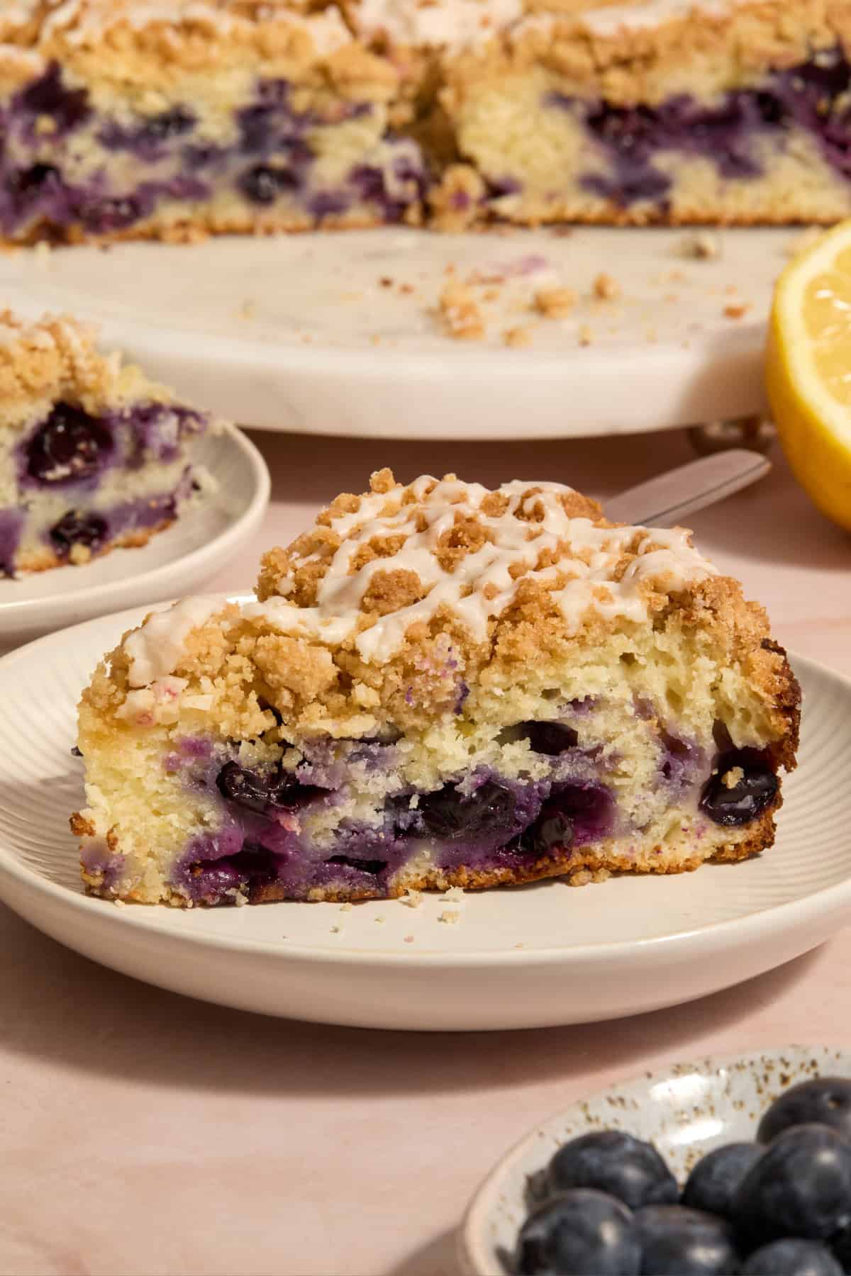 Slice of blueberry lemon coffee cake on plate.