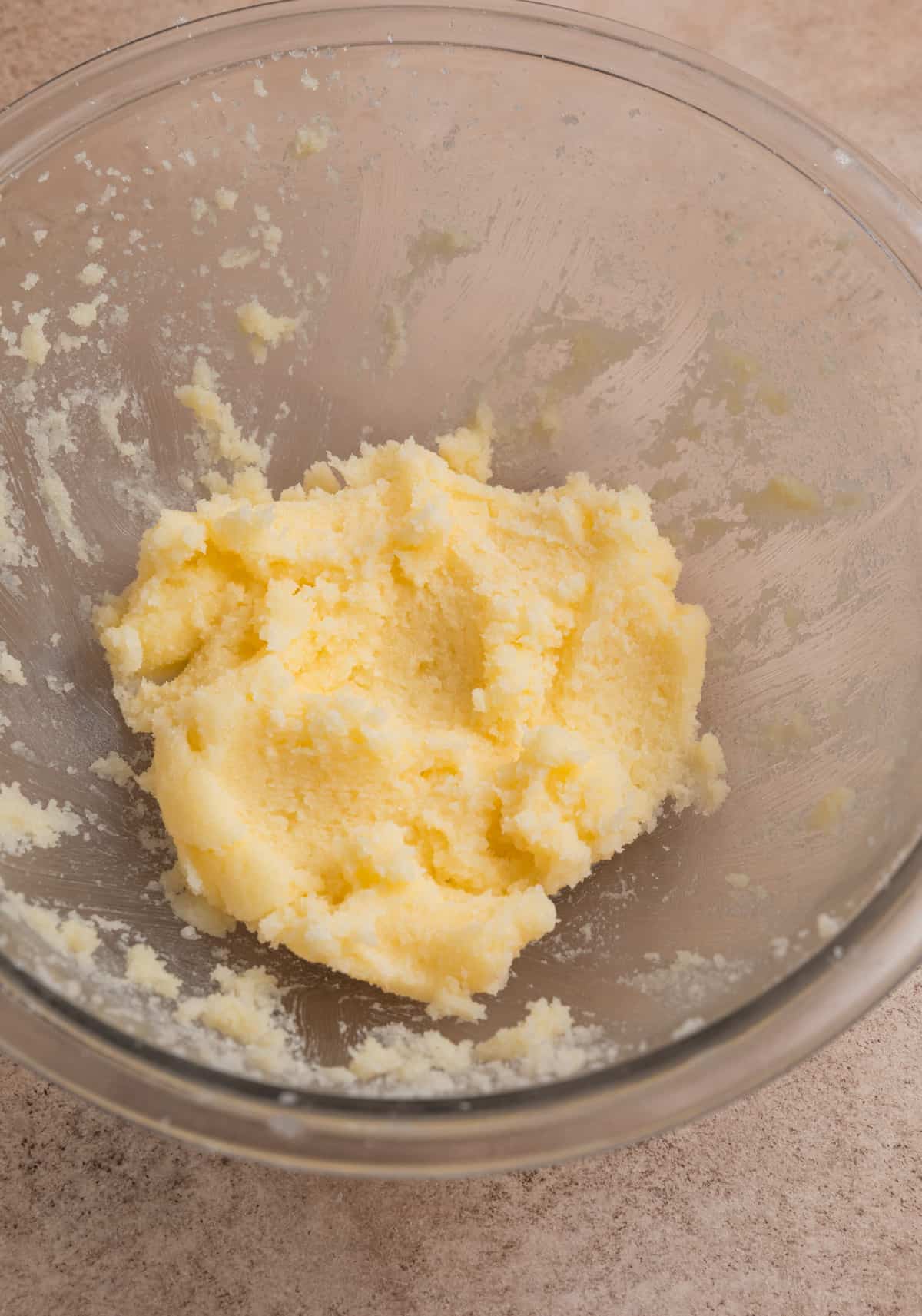 Creamed butter and sugar in glass mixing bowl