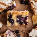 Slice of blueberry lemon coffee cake with streusel topping laid on its side to show texture.