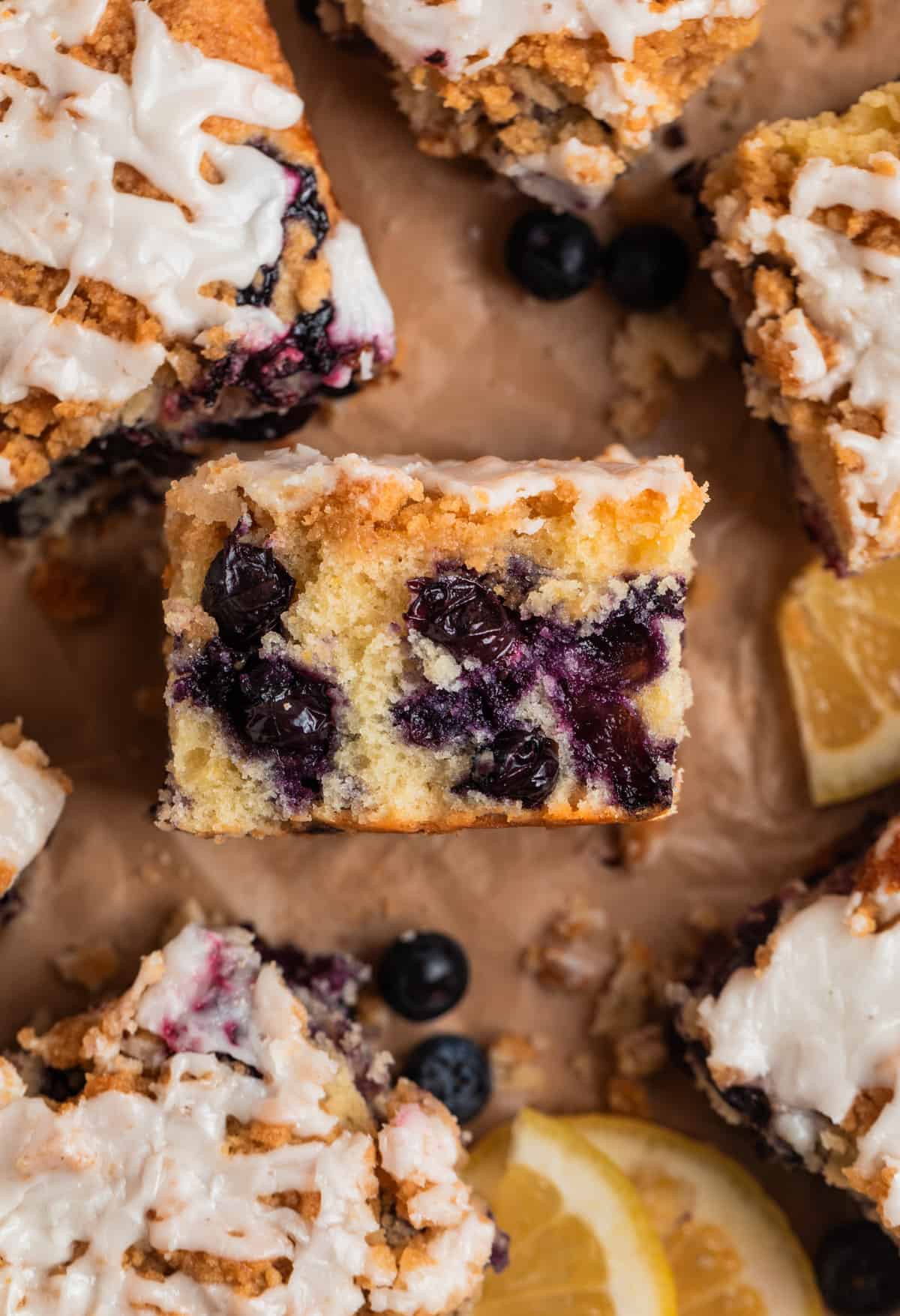 Slice of blueberry lemon coffee cake propped on its side to show texture of cake layer.