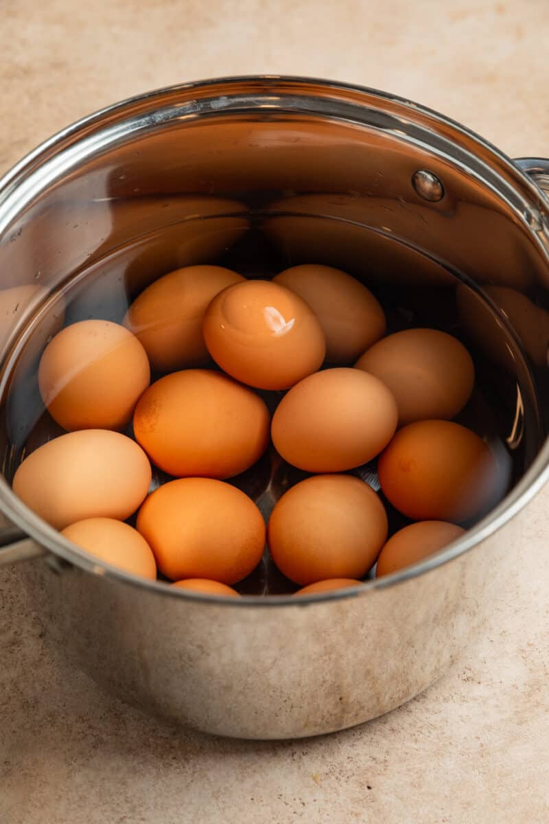Eggs in pot with water before boiling.