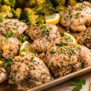 Lemon chicken on sheet pan topped with chopped parsely.
