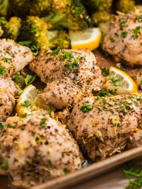 Lemon chicken on sheet pan topped with chopped parsely.