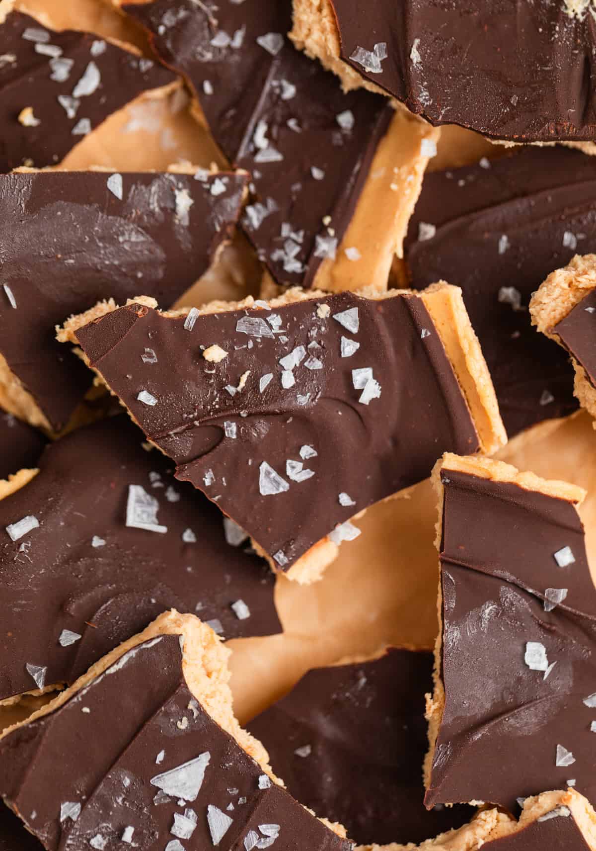 Frozen peanut butter Greek yogurt bark covered in chocolate with sea salt flakes on top.
