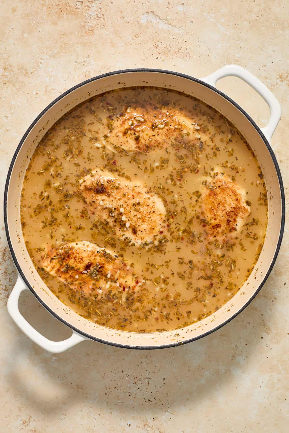 Chicken added to skillet with orzo and broth.
